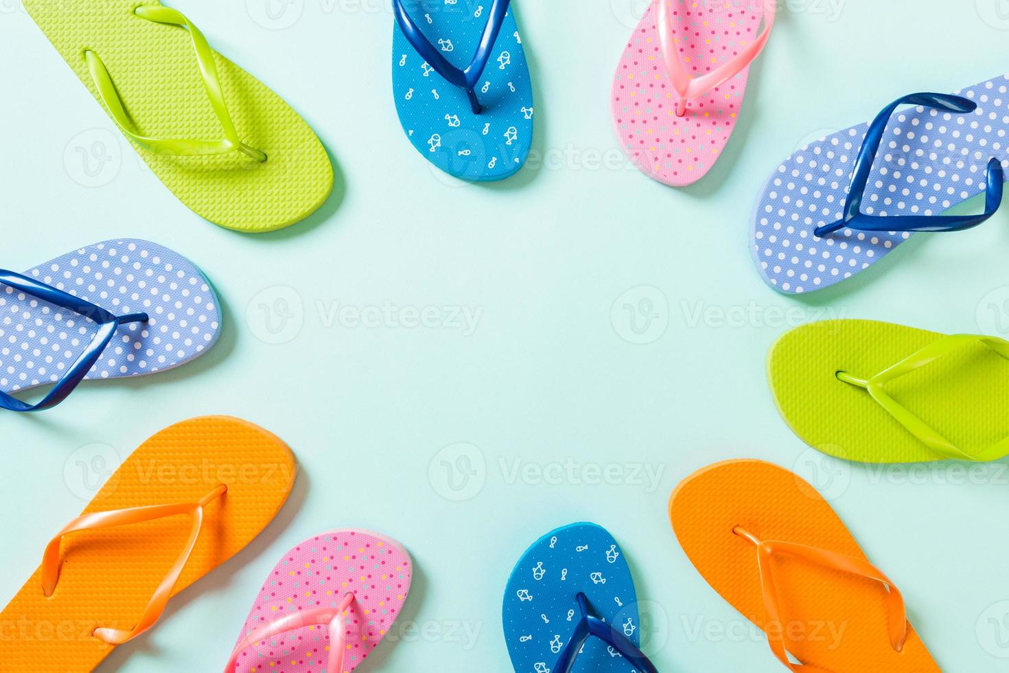 a lot of flip flop colored sandals, summer vacation on colored background, copy space top view photo