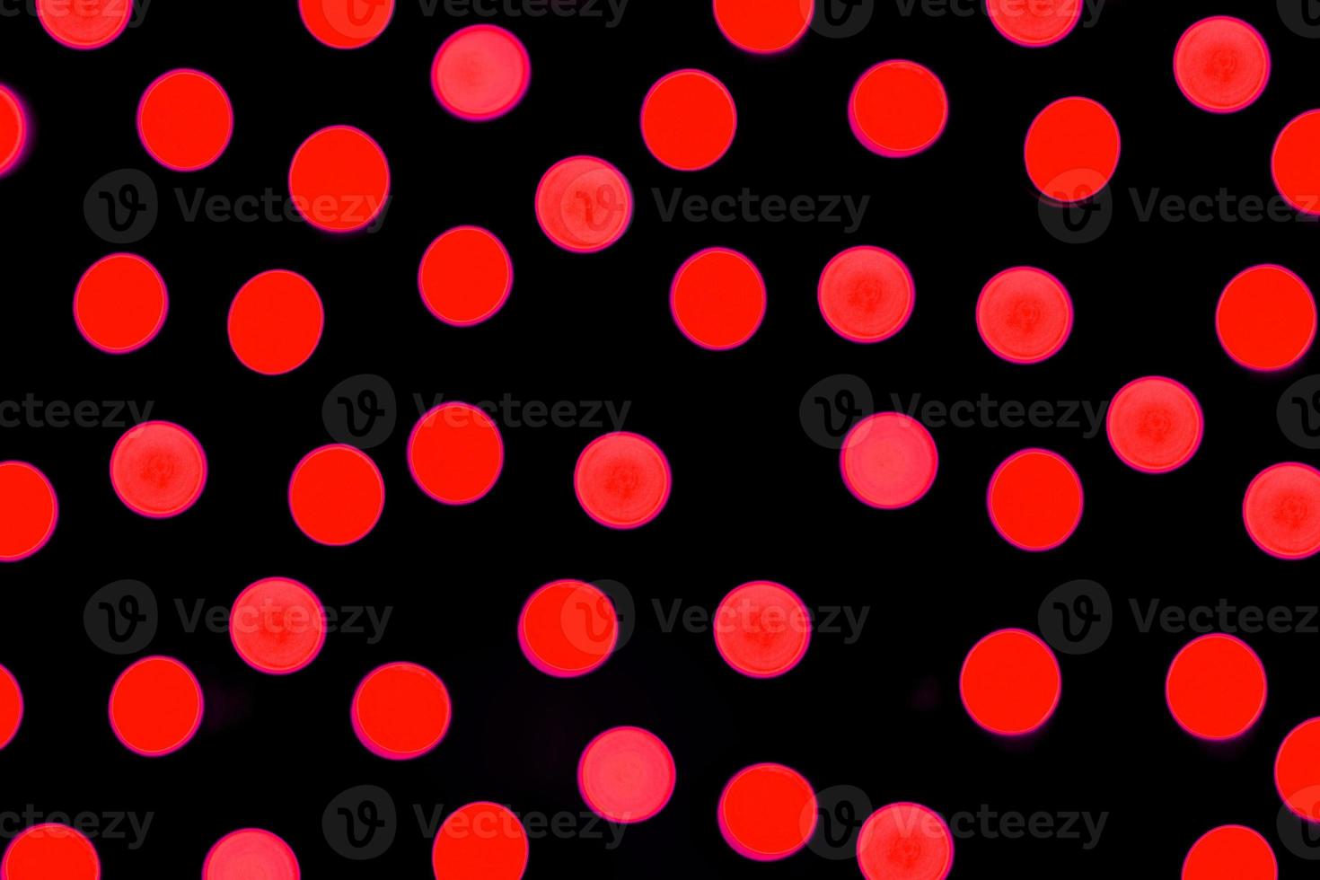 Unfocused abstract red bokeh on black background. defocused and blurred many round light photo