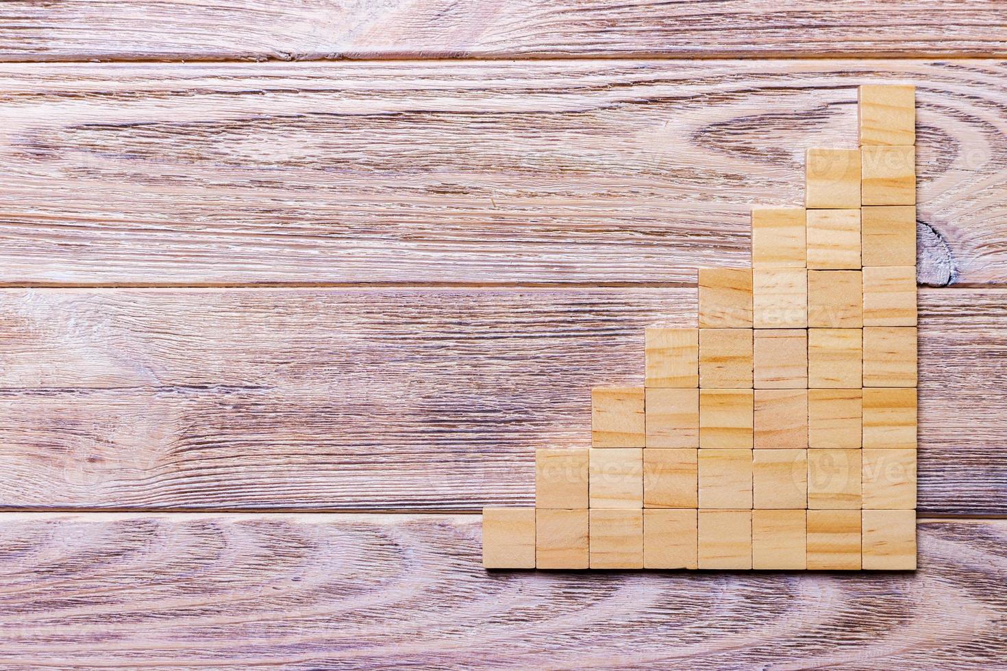 A wooden blocks cube over black wooden textured background with copy space for add word text title. Concept or conceptual Wood block stair or eight steps. Cubic photo