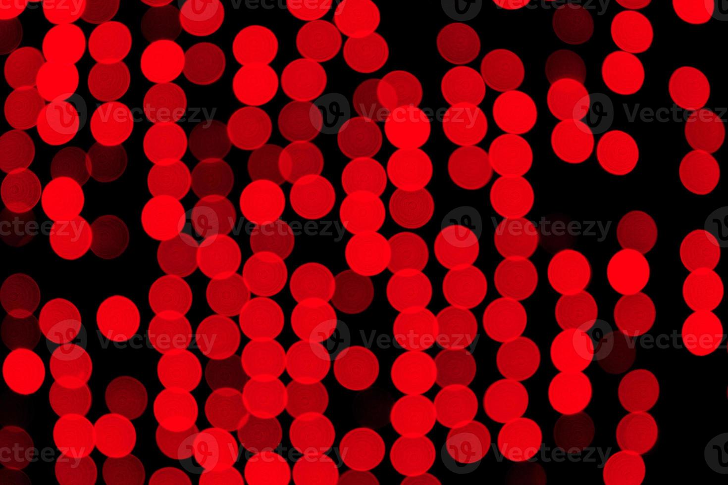 Unfocused abstract red bokeh on black background. defocused and blurred many round light photo