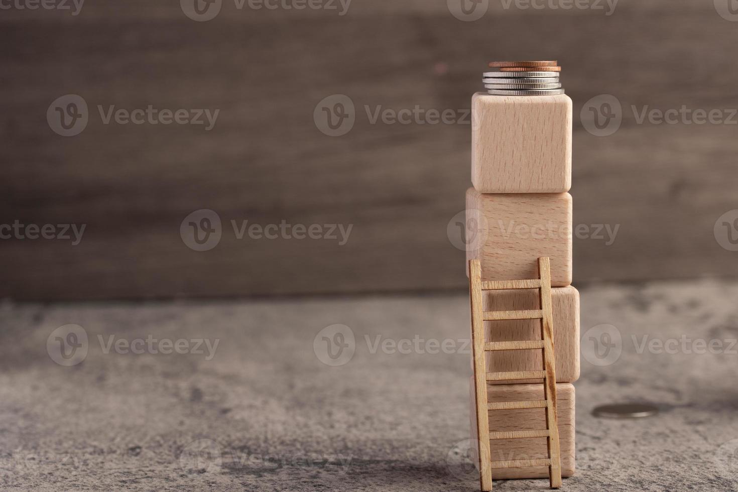 Stacked wooden blocks above as money. Gun up concept to earn money.Copy space photo