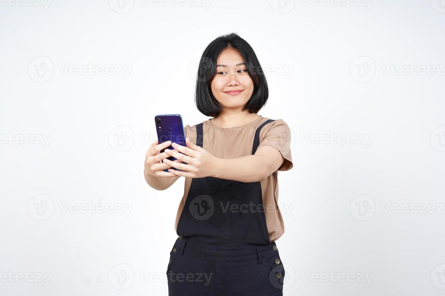 Take a Selfie using Smartphoneof Beautiful Asian Woman Isolated On White Background photo