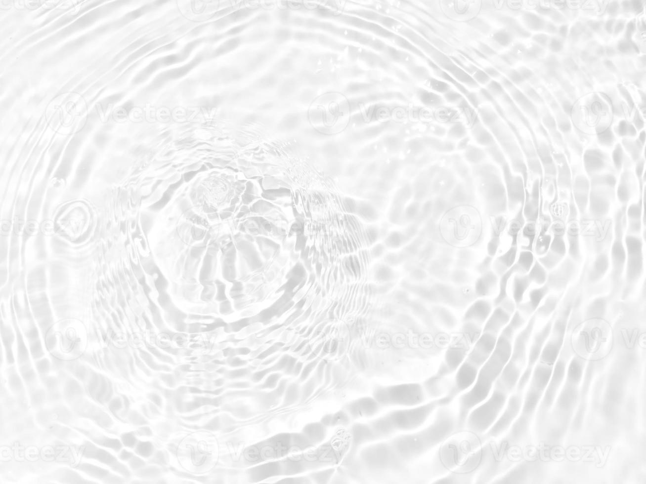 Defocus blurred transparent white colored clear calm water surface texture with splashes and bubbles. Trendy abstract nature background. Water waves in sunlight with copy space. White water shine photo