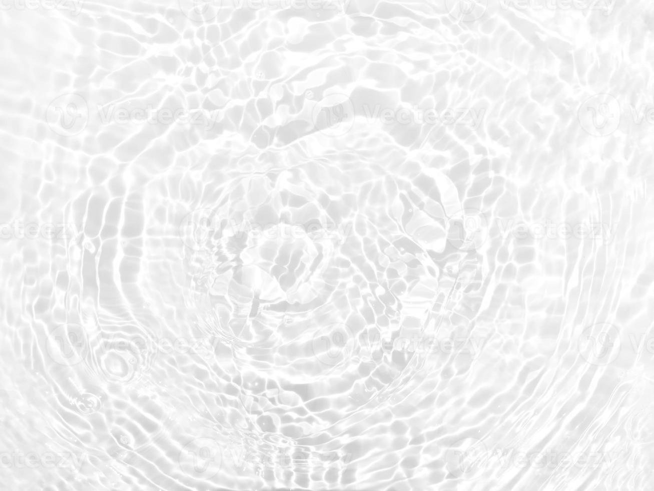 Defocus blurred transparent white colored clear calm water surface texture with splashes and bubbles. Trendy abstract nature background. Water waves in sunlight with copy space. White water shine photo