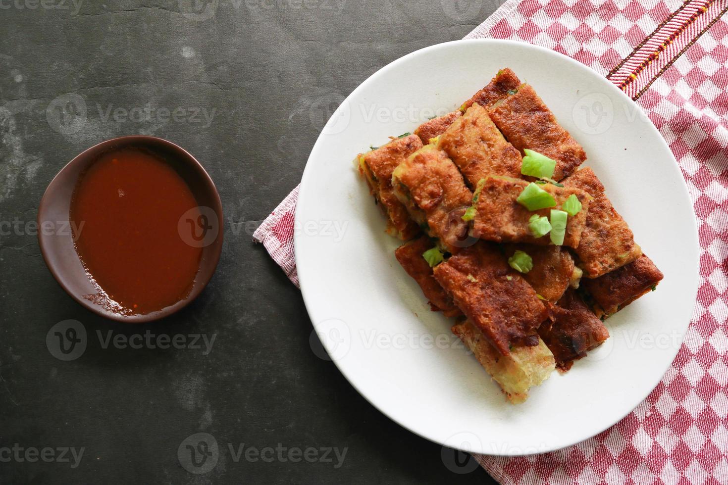 Martabak Telor or Murtabak Telur or mutabbaq. Savory pan-fried pastry stuffed with egg, meat and spices. Martabak Telur is one of Indonesia street food. photo