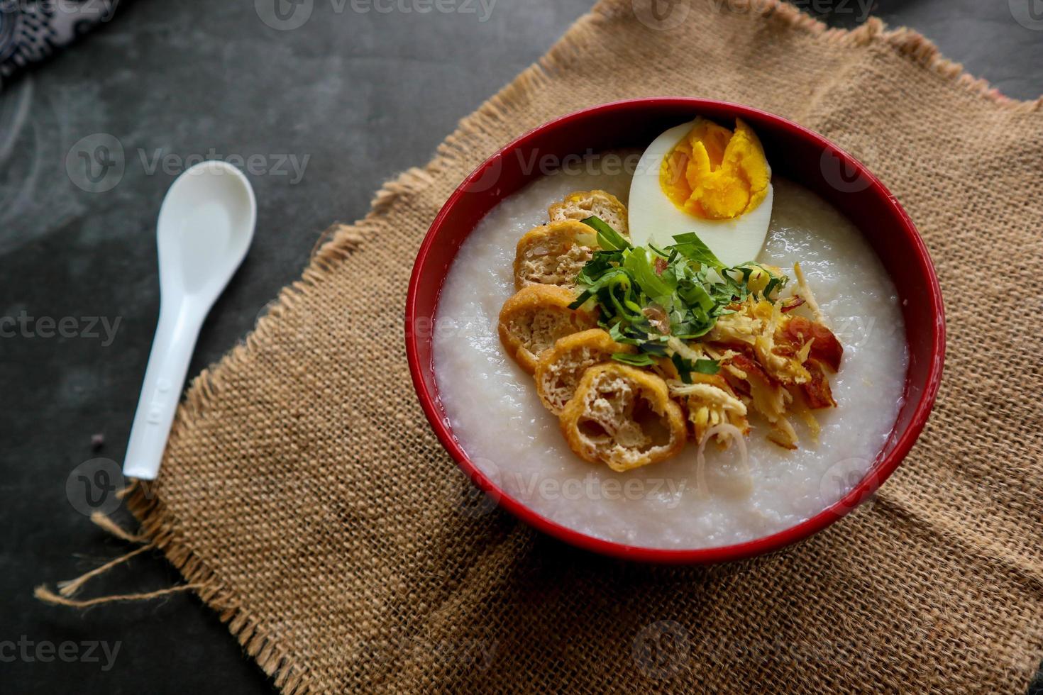 congee porridge with chicken slice, tofu, egg. congee porridge from hong kong. chinese food photo