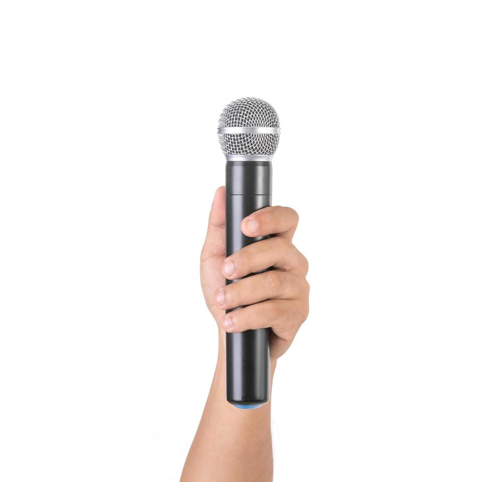 Hand holding black wireless microphone in studio. Isolated on white photo