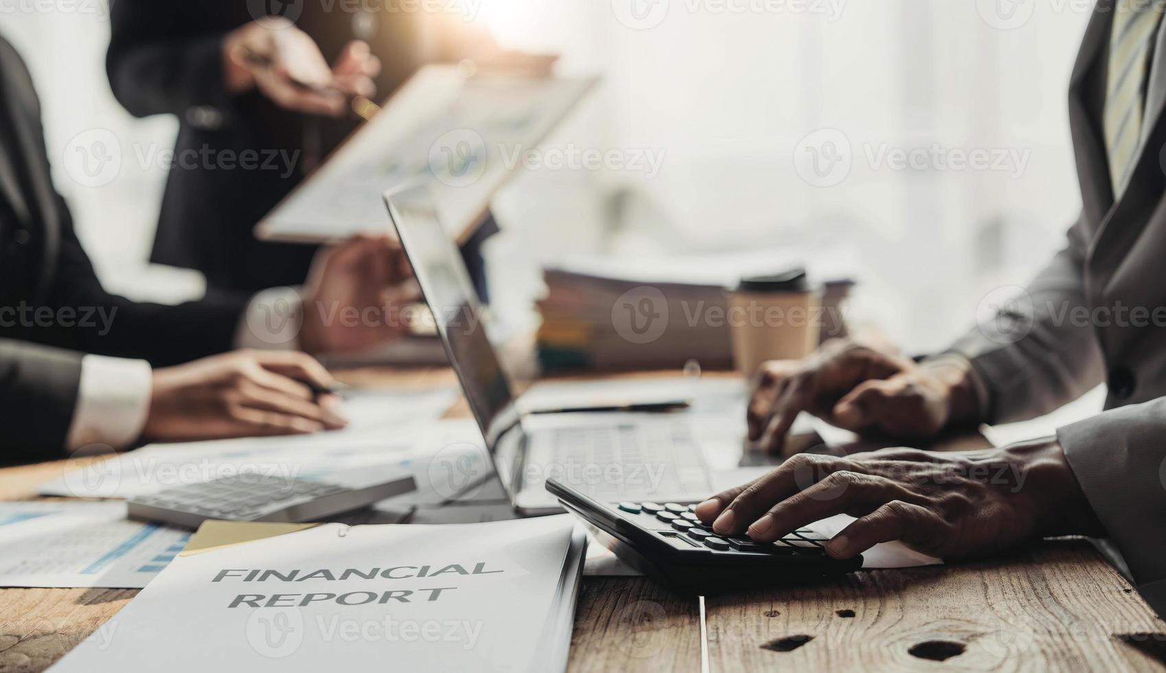 Business People Meeting using laptop computer,calculator,notebook,stock market chart paper for analysis Plans to improve quality next month. Conference Discussion Corporate Concept photo