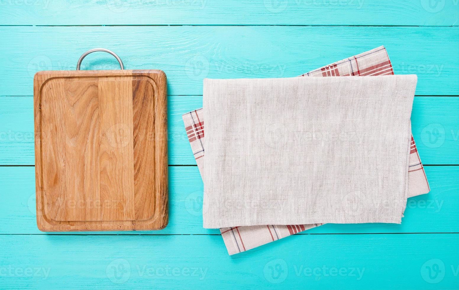 wooden empty cutting board and tablecloth on wooden background top view photo