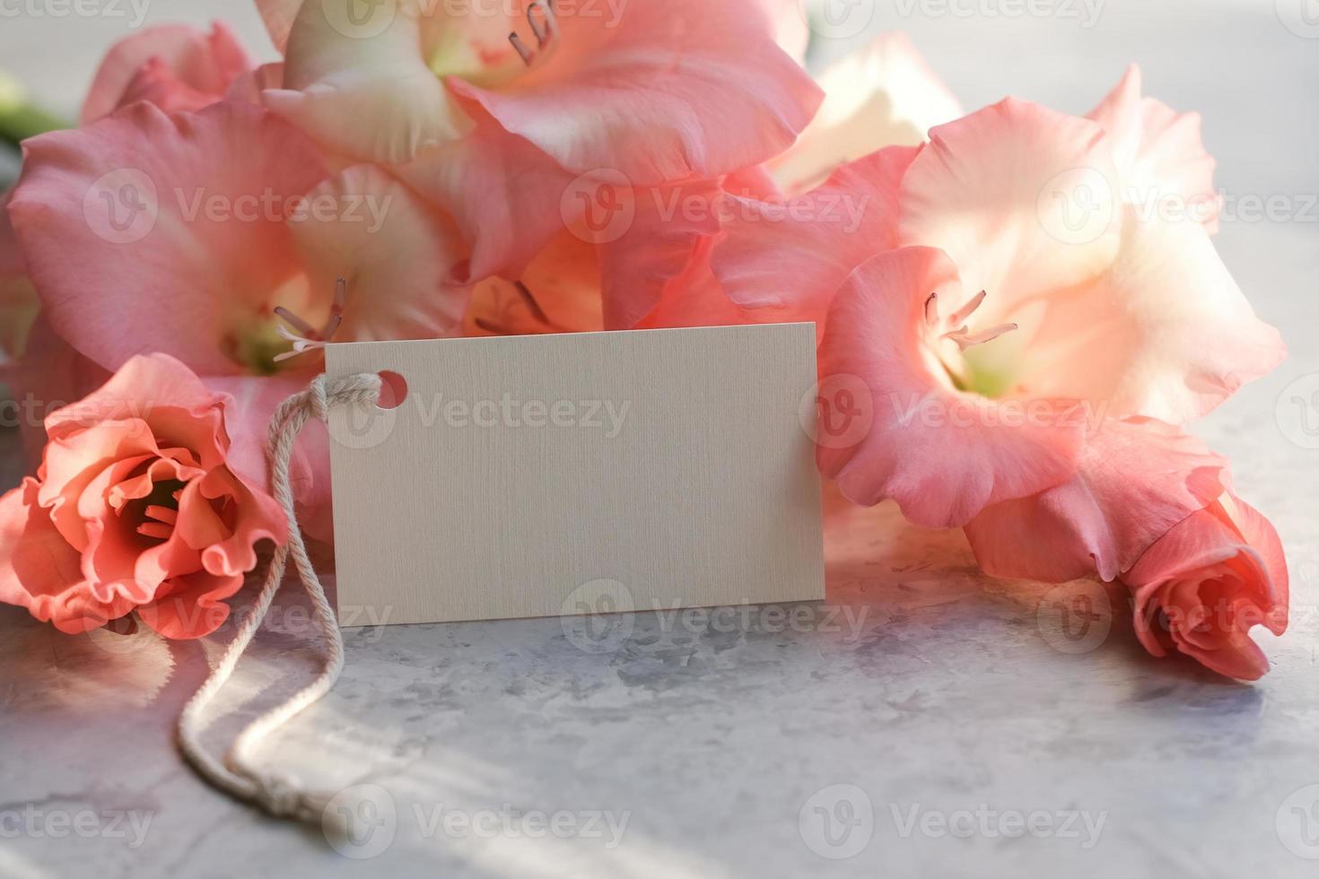 Bouquet of flowers and blank white card for text. Mockup tag. Postcard photo