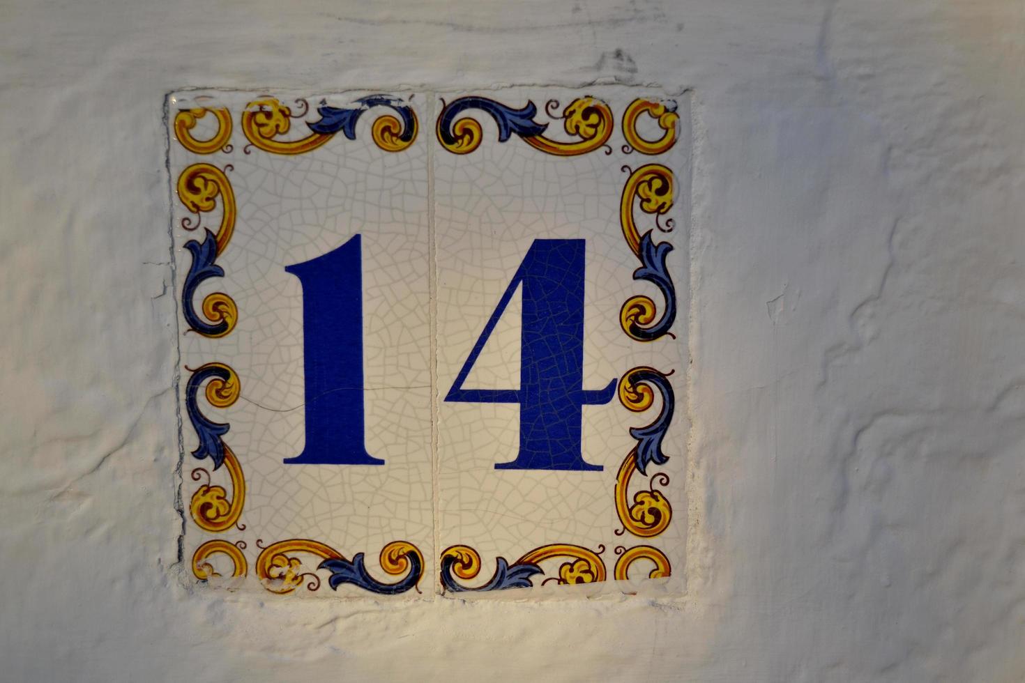 Tile decorated with the number fourteen photo