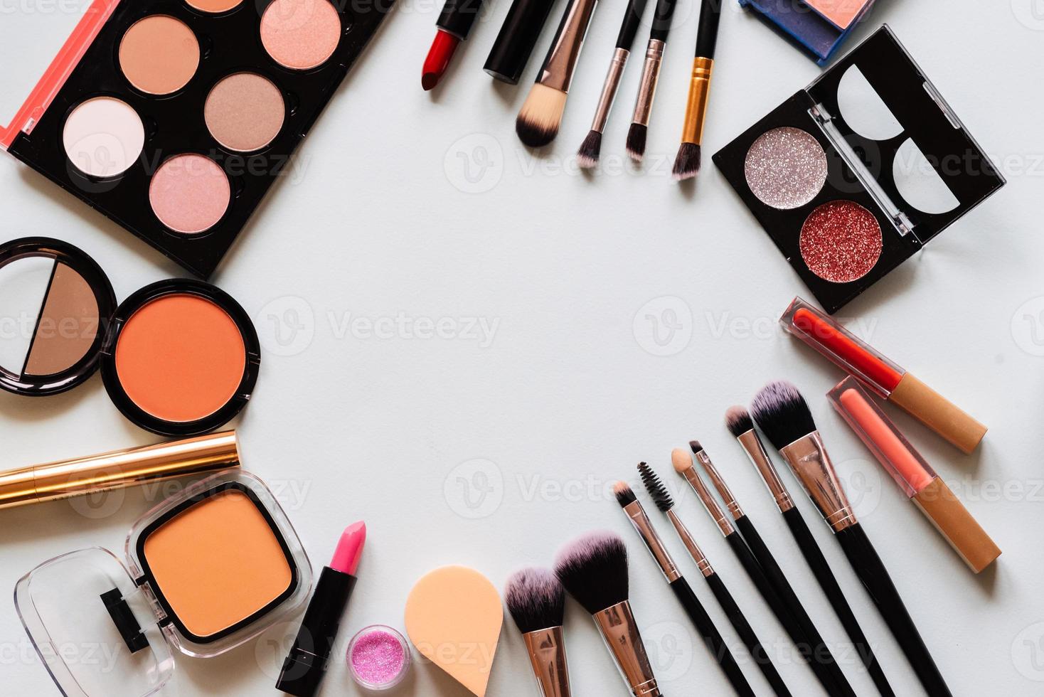 Set of professional cosmetic make-up brushes, shadows, lipstick - isolated light background. Overhead view. Place text photo