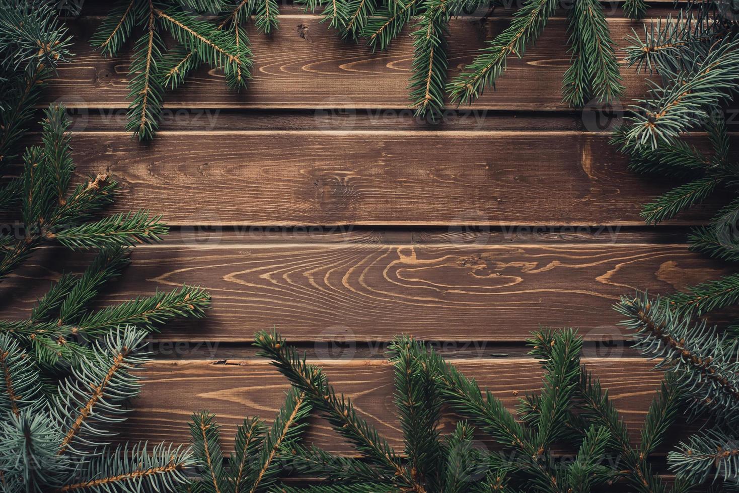 frame from branch of Christmas tree on old wood photo