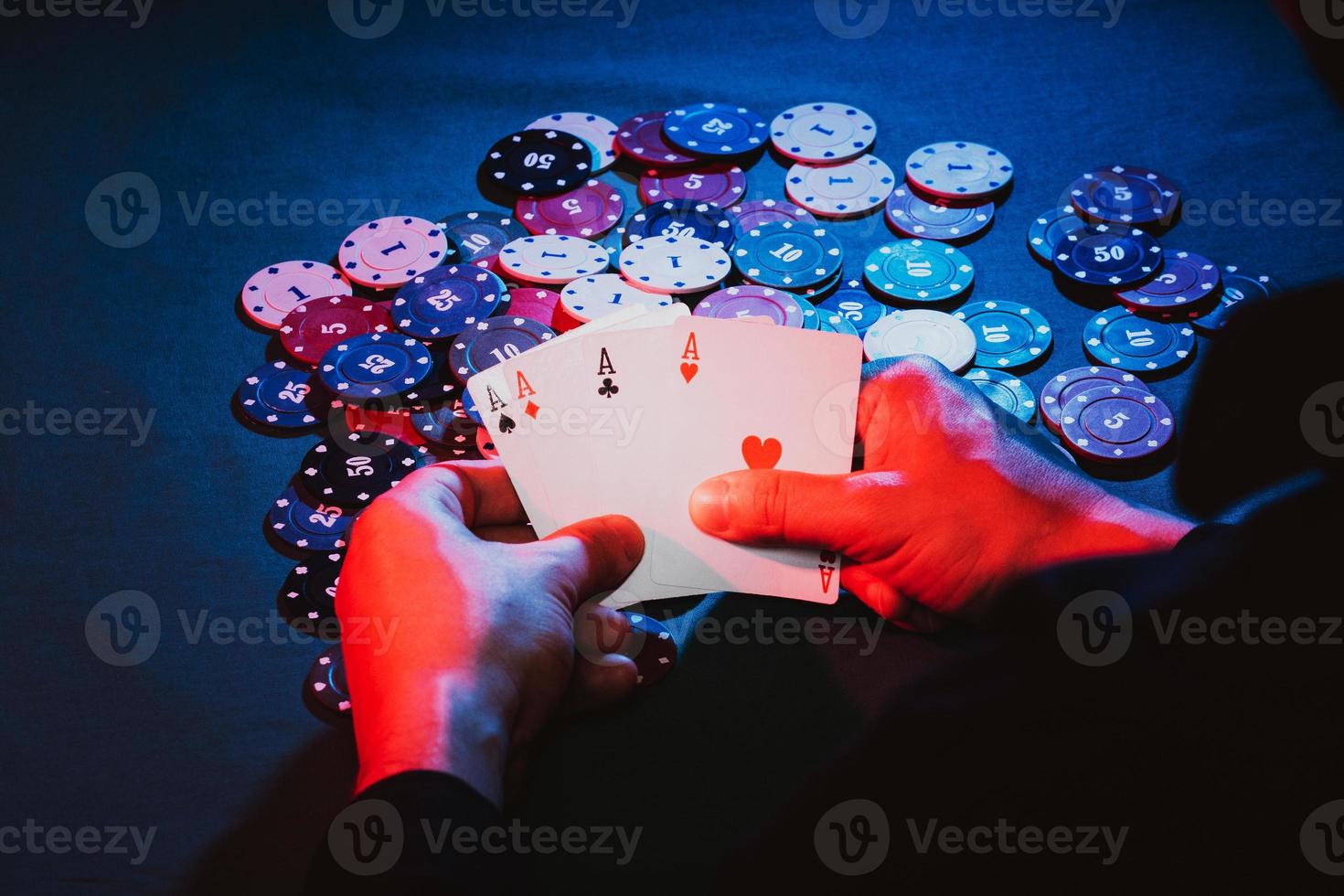 men's hands hold cards , a set of aces on the background of playing chips photo