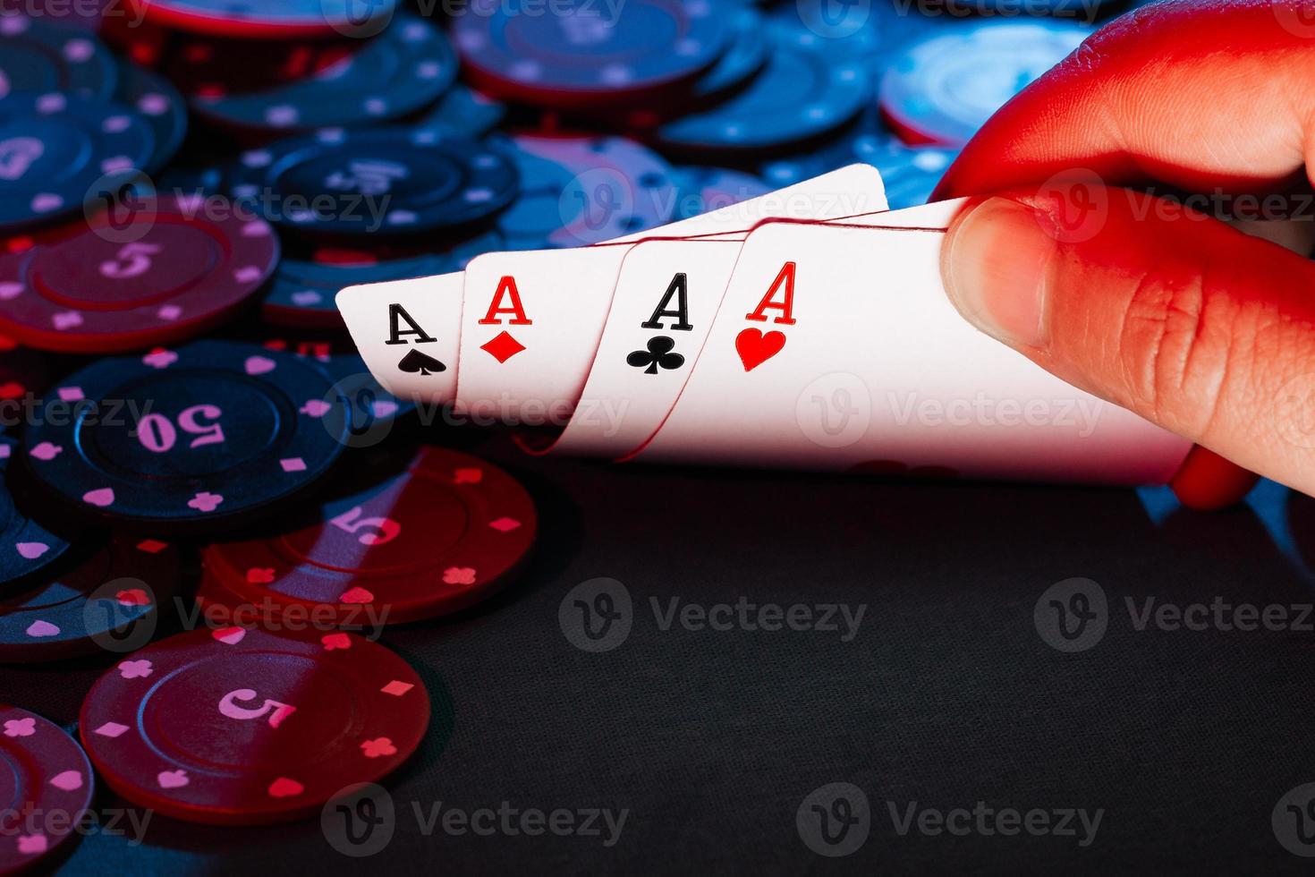 men's hands hold cards , a set of aces on the background of playing chips photo