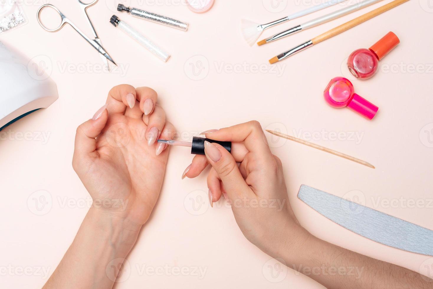 Manicure. A girl paints her nails. Hands close up 17560200 Stock Photo