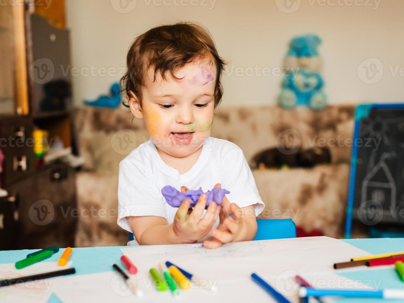 the boy is engaged in modeling from dough for modeling figures photo