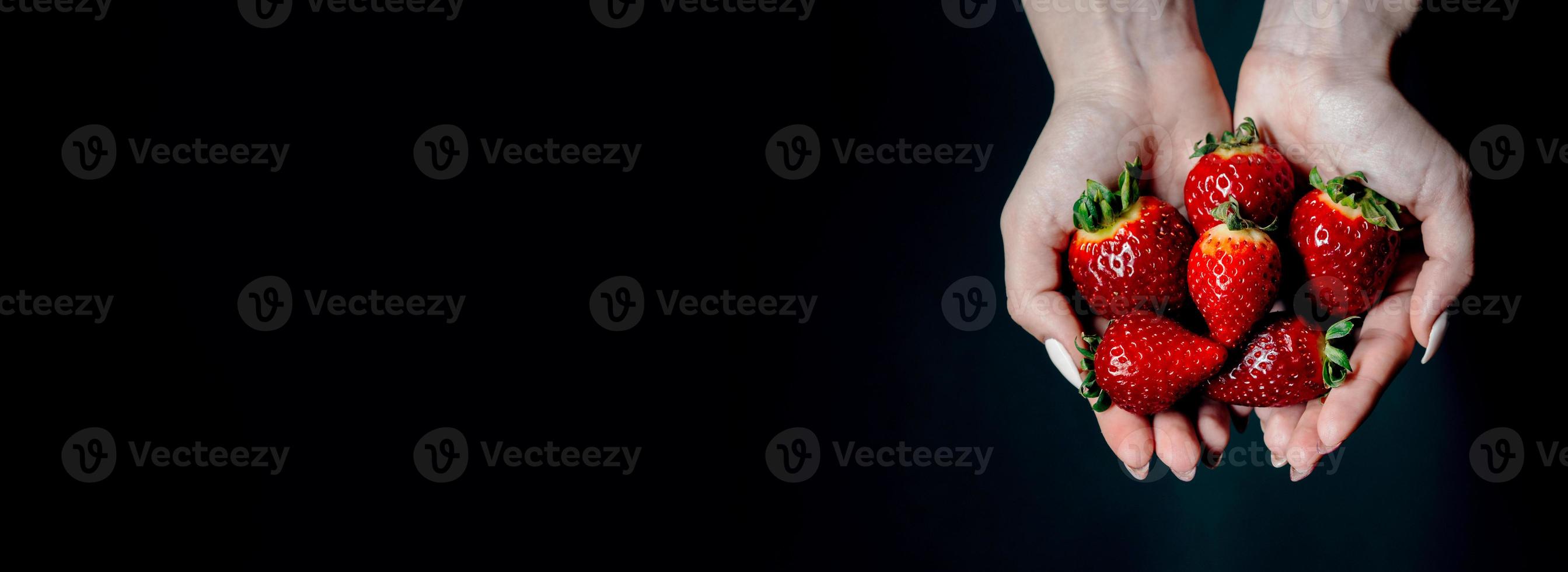 ripe strawberry berries in women 's hands. space for your text photo