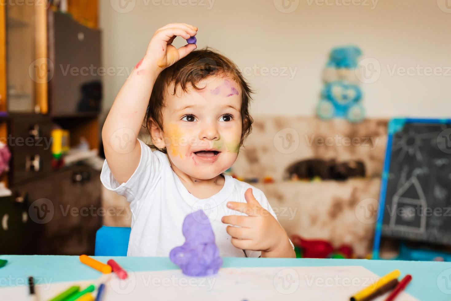 boy sculpts from dough for modeling figures photo