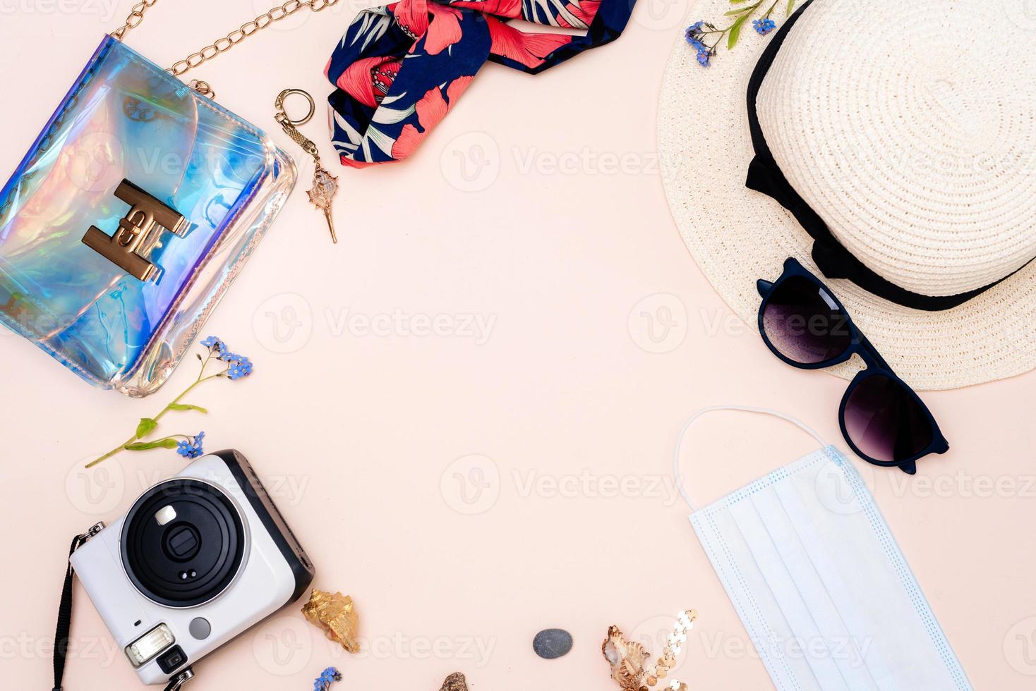 summer travel accessories. women's set of adult toys, camera, hat, glasses, protective mask and gloves on a light background. space for your text photo