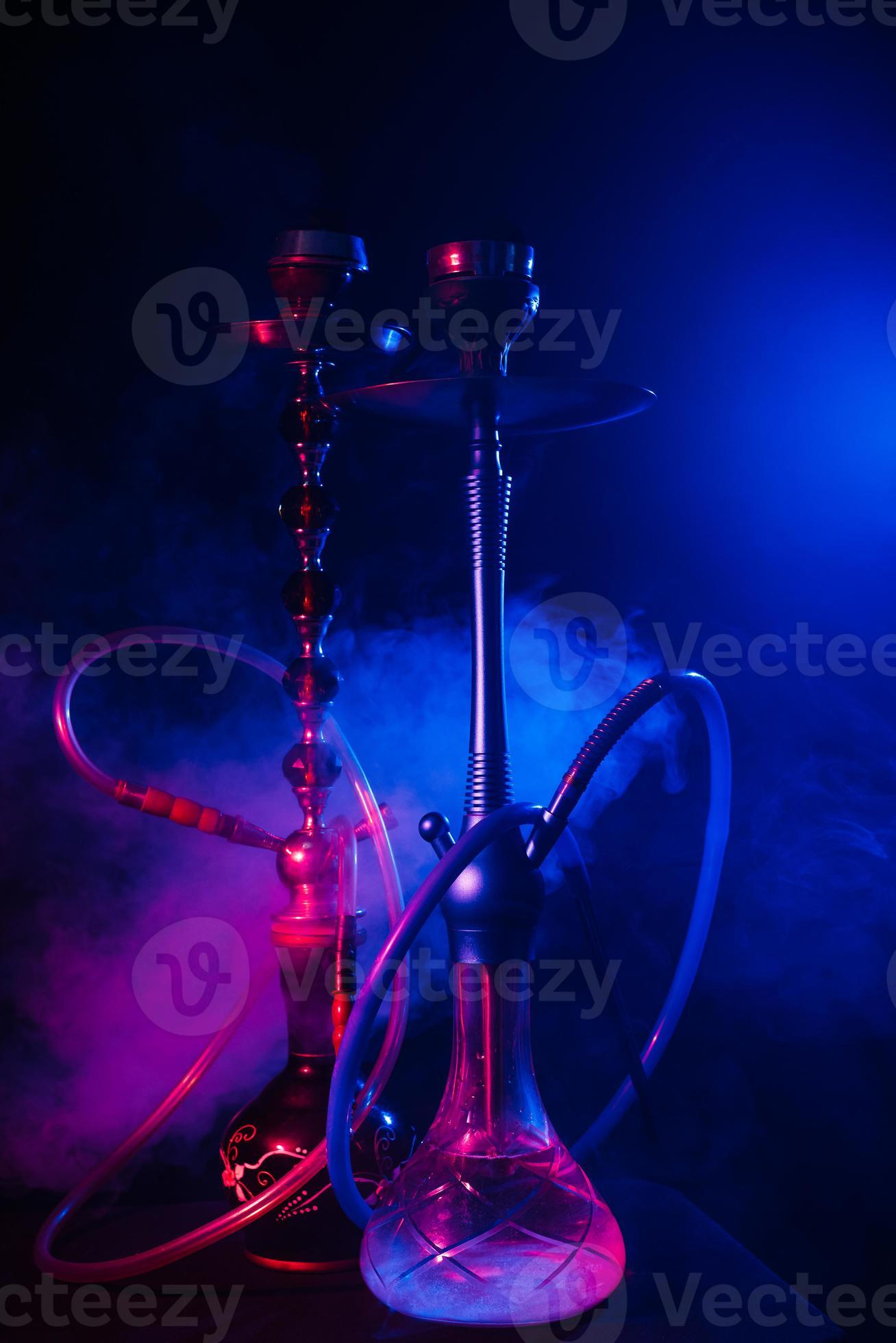 Fashionable hookah with a cloud of smoke on a black background with red