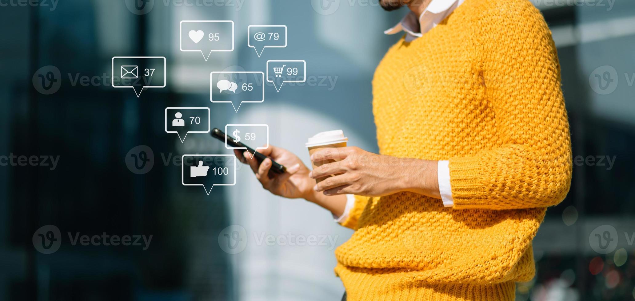 Asian man typing smartphone, keyboard  with laptop computer ofSocial media and Marketing virtual icons photo