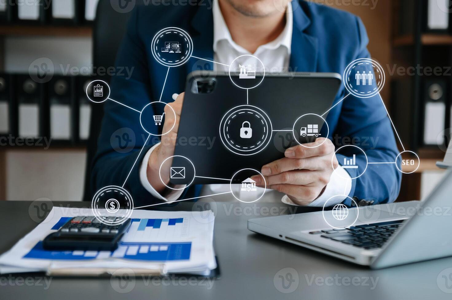 Businessman hand working digital marketing media in virtual screen with mobile phone and modern compute with VR icon diagram at office in morning light photo