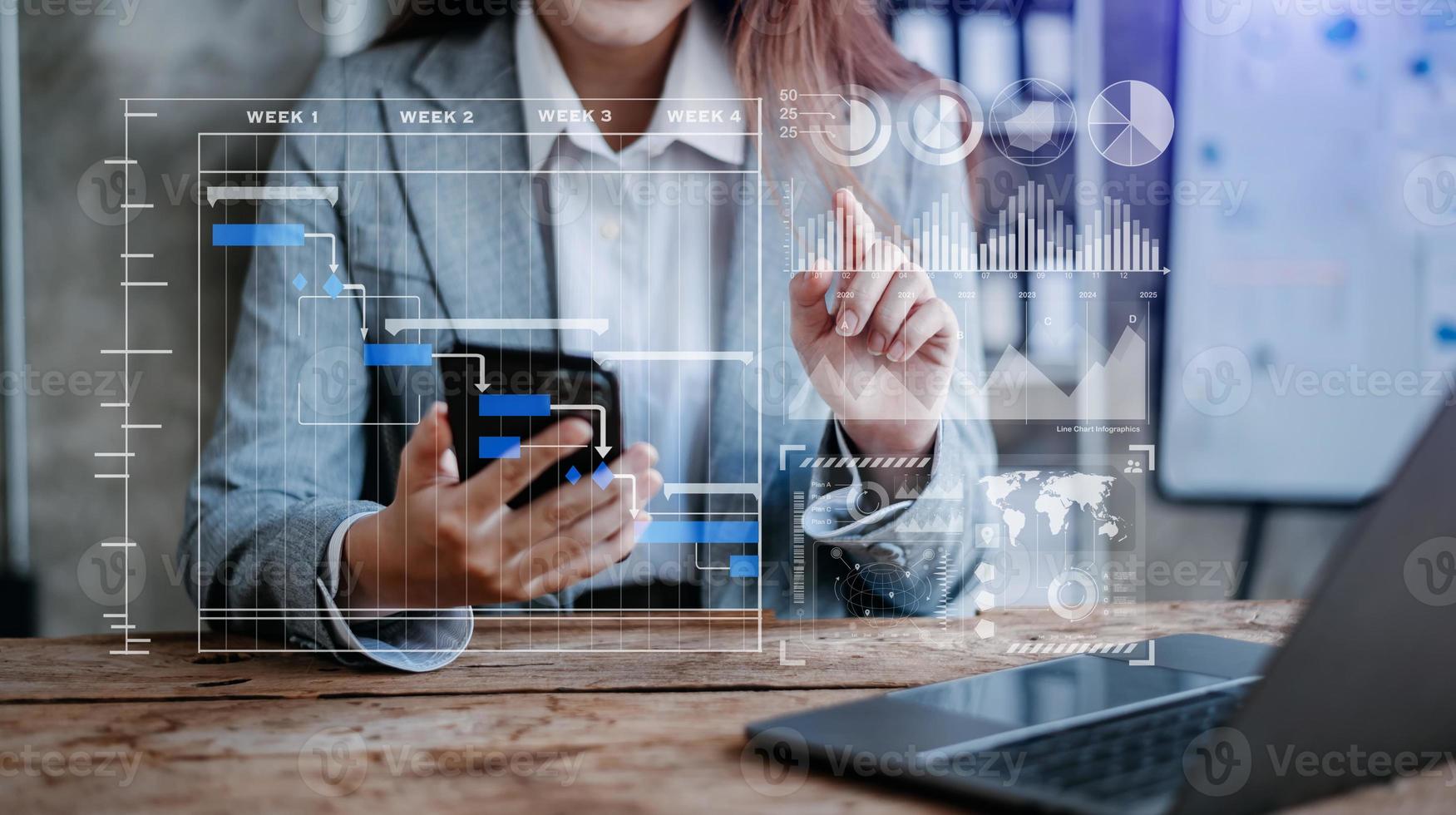 Businessman hand Project manager working and update tasks and Gantt chart scheduling virtual diagram.with smart phone, tablet and laptop photo