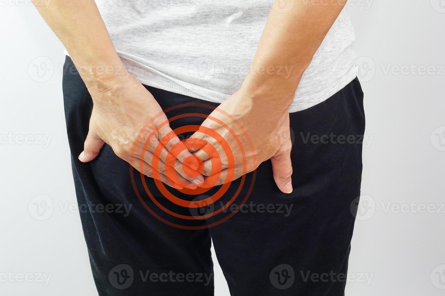 Woman hands touching her buttocks area suffering from pain. Health care and medical concept. photo