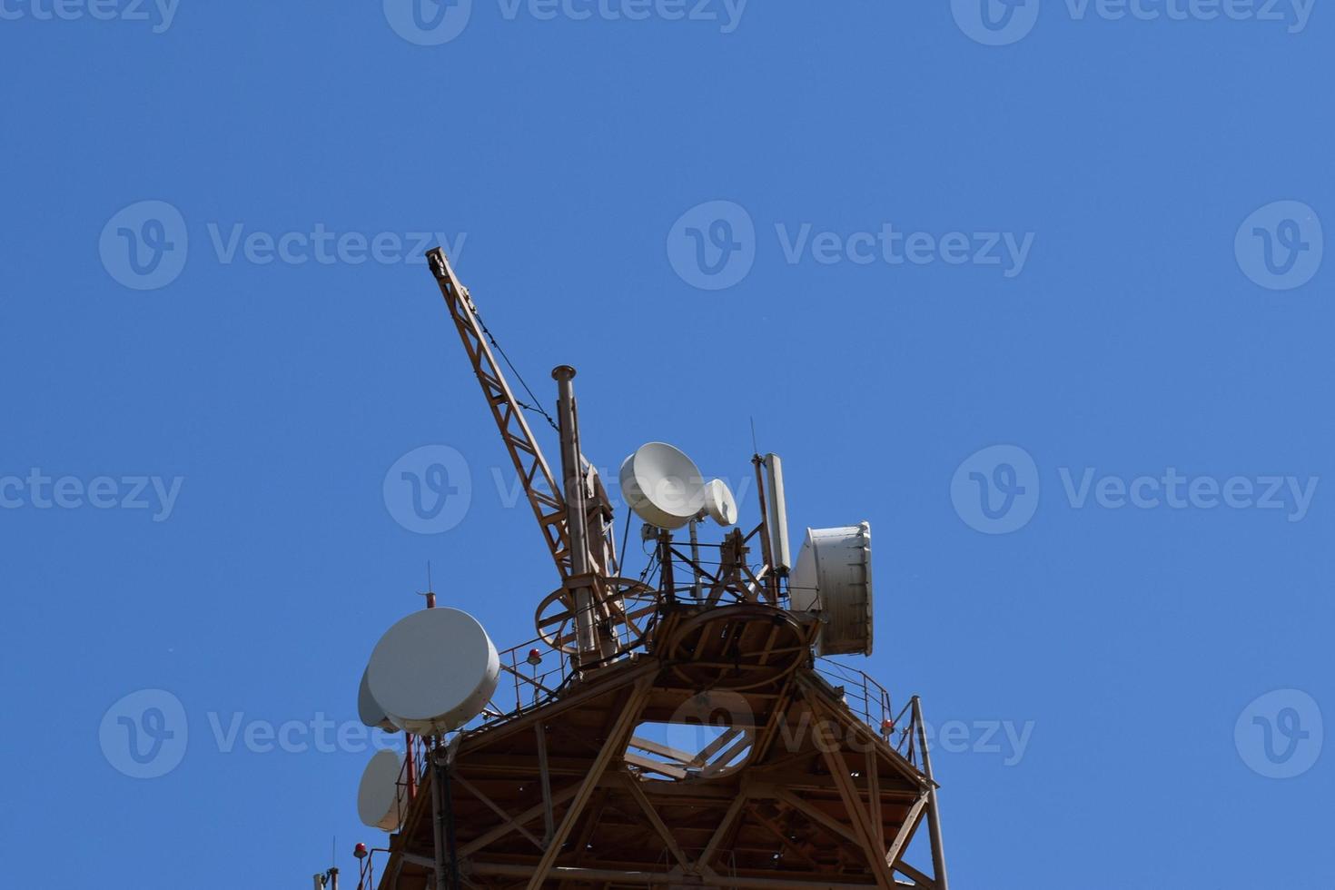 Satellite antennas and repeaters on the tower photo