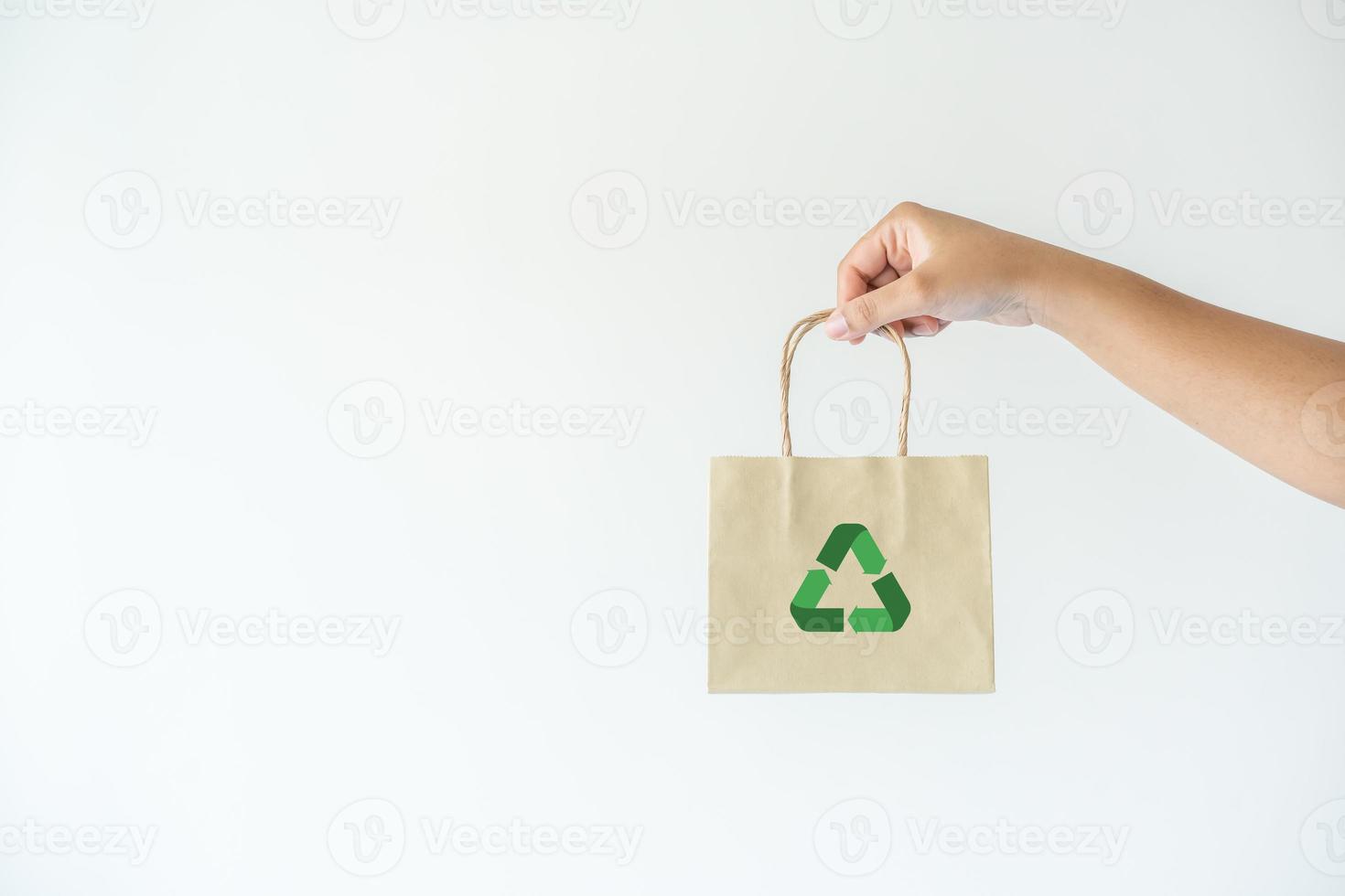 Woman carrying paper bag concept of reuse, recycle the object to zero waste. Concept of sustainability using of recycled paper bags for shopping. photo