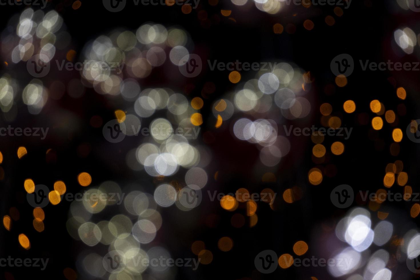 abstract bokeh blur light orange and white glowing flare pattern black background photo