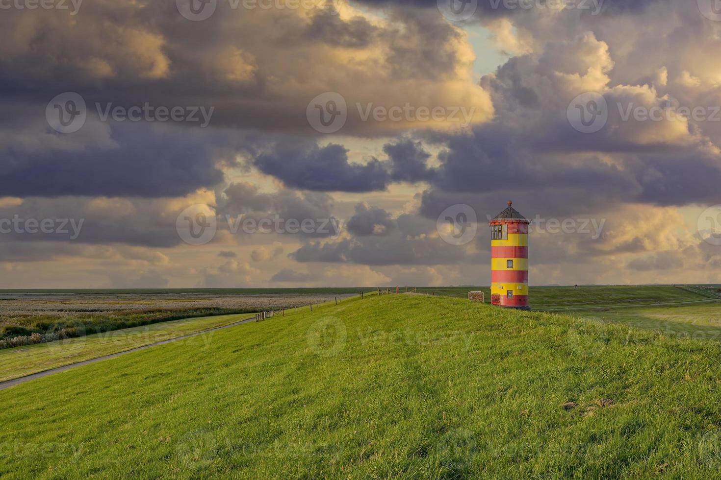 the famous Lighthouse of Pilsum at North Sea in East Frisia, Germany photo