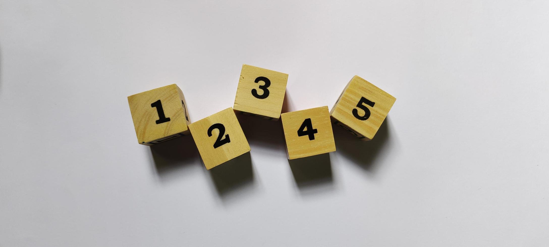 Number 1 to 5 arrangement on wooden cubes, educational background photo