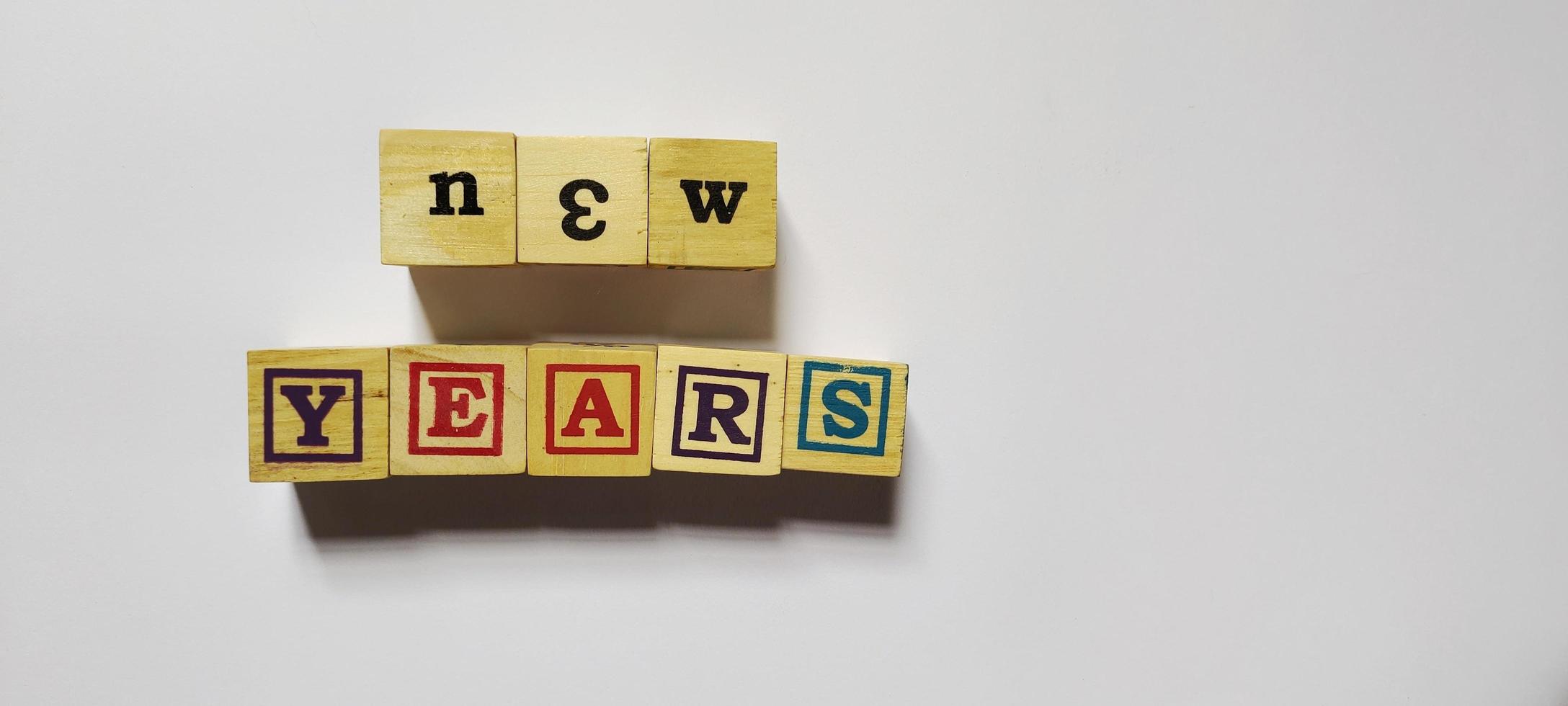 New years word in wooden cubes concept photo