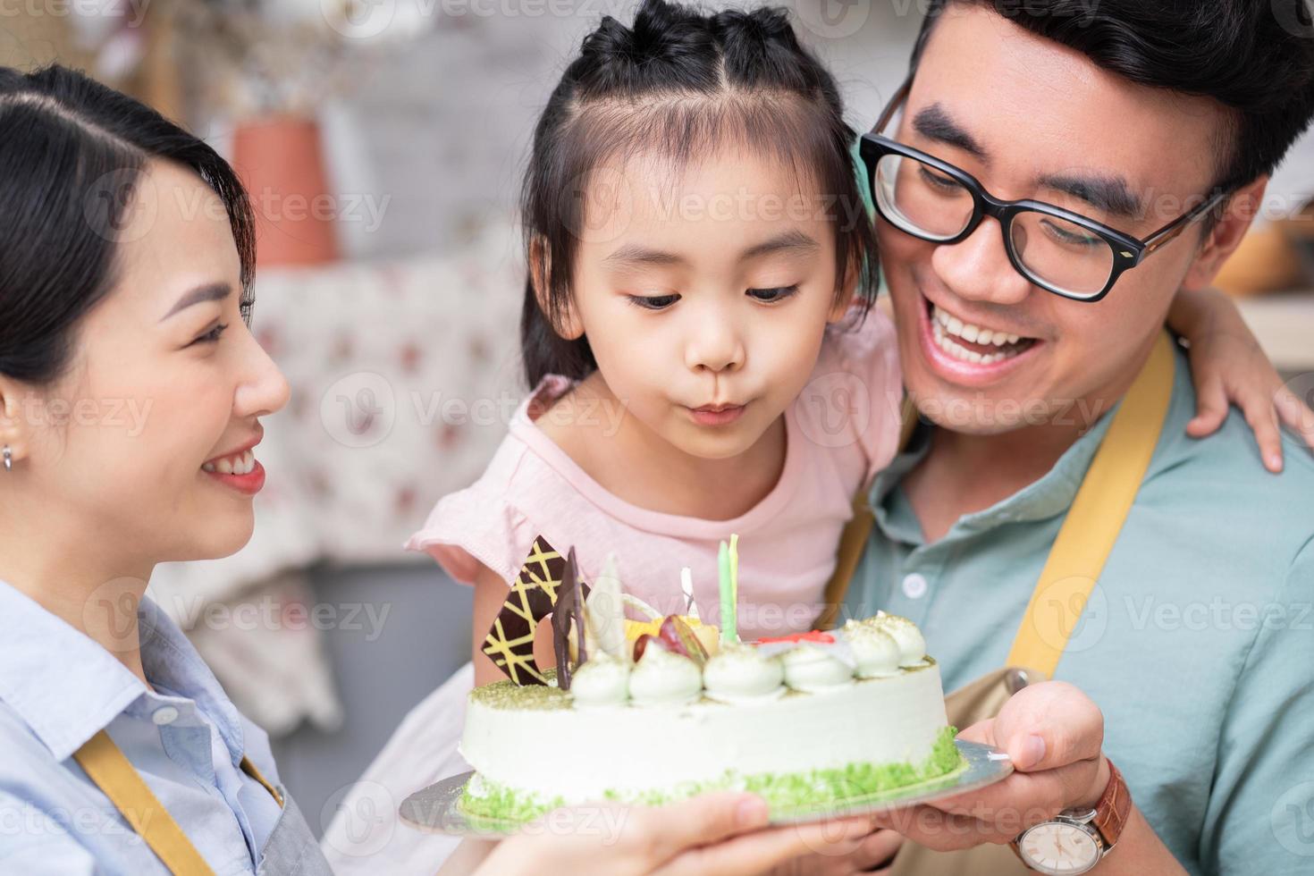 Young Asian family, birthday party photo