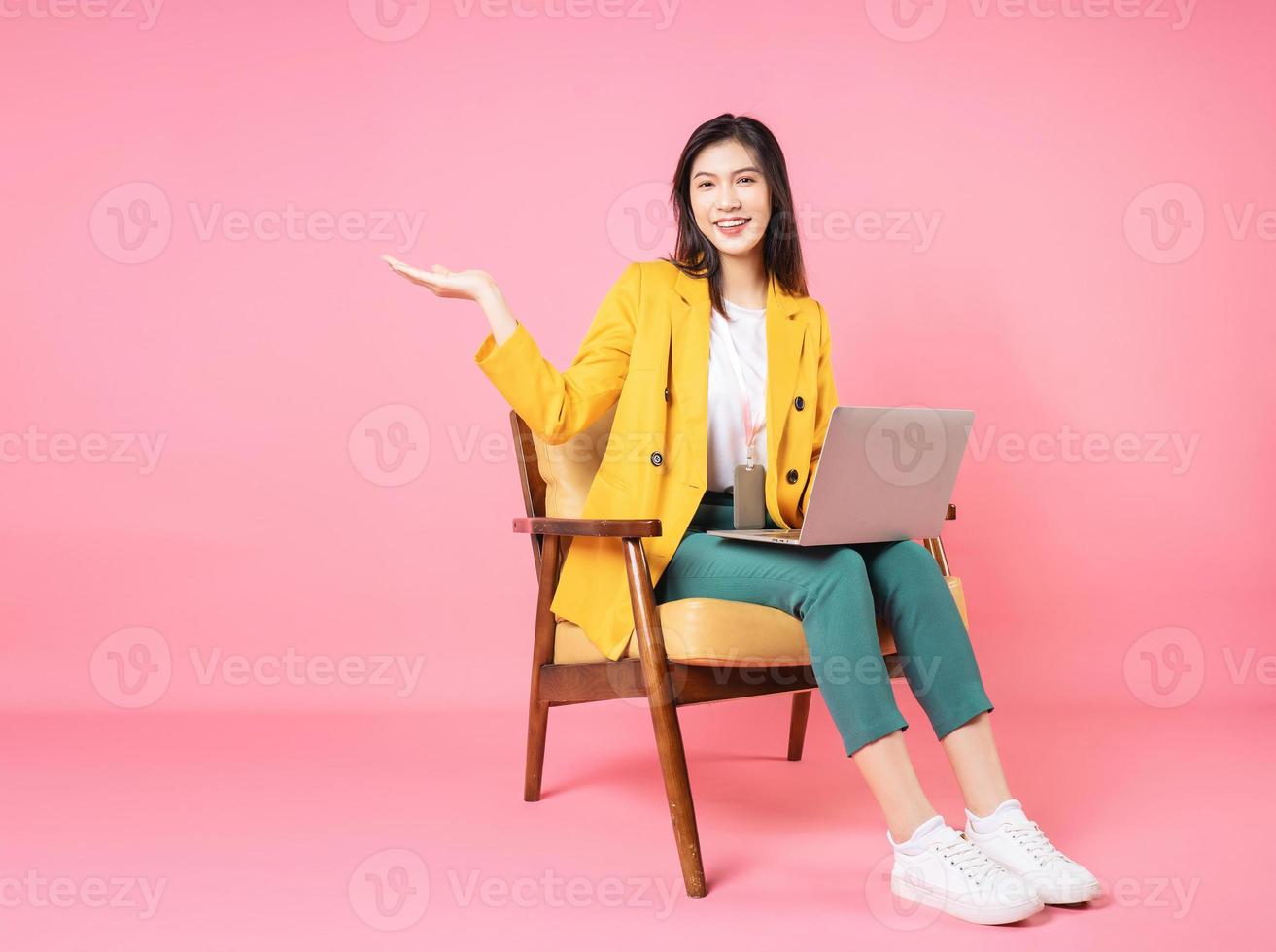 Image of young Asian businesswoman sitting on chair photo