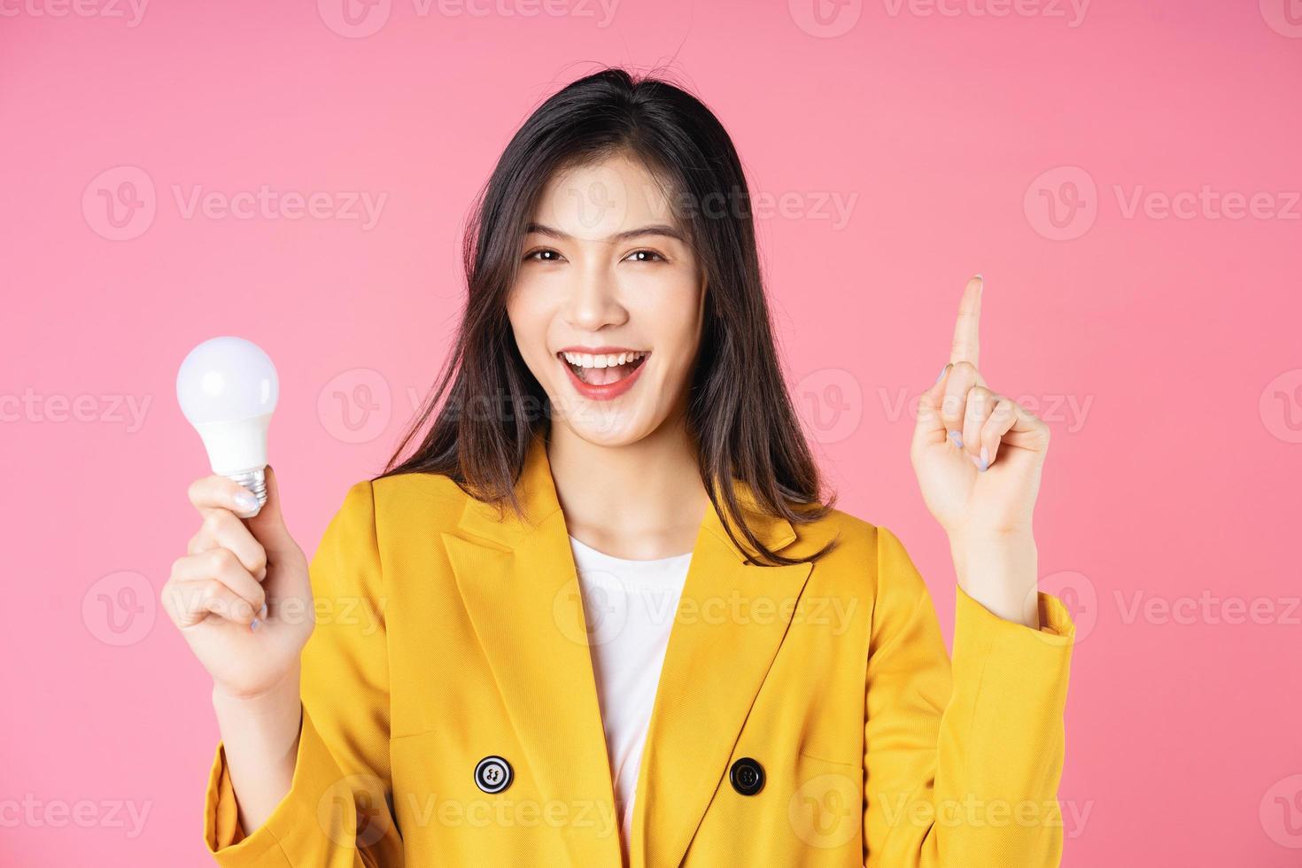 Image of young Asian businesswoman holding light bulb, brainstorm concept photo
