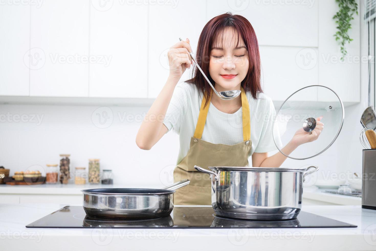 Image of young Asian woman in the kitchen photo