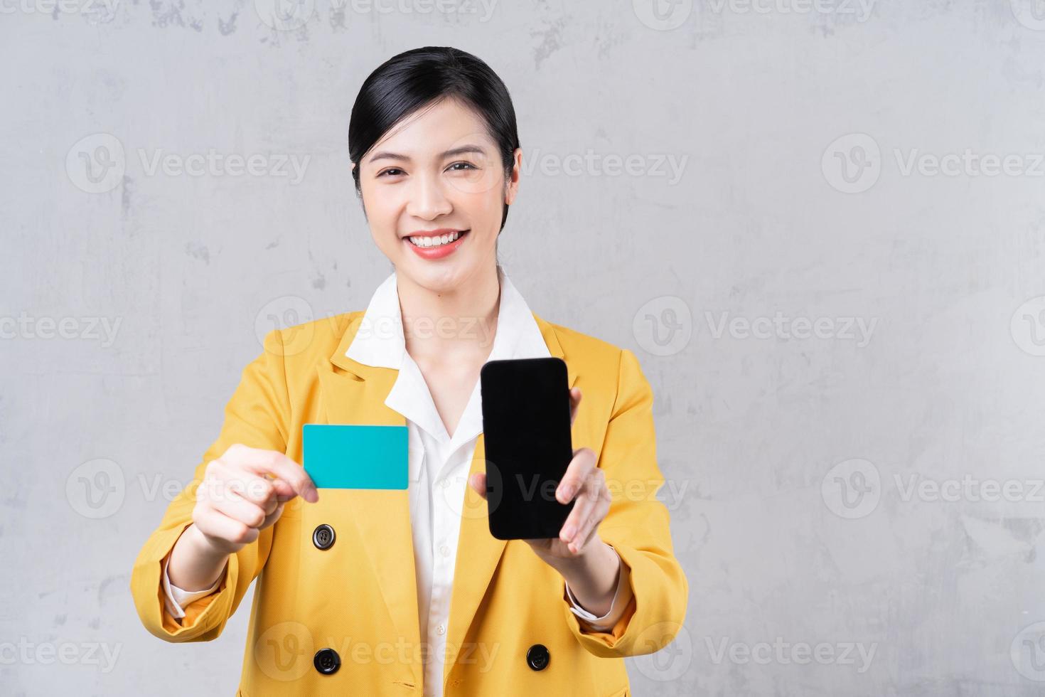 Image of young Asian woman holding bank card photo