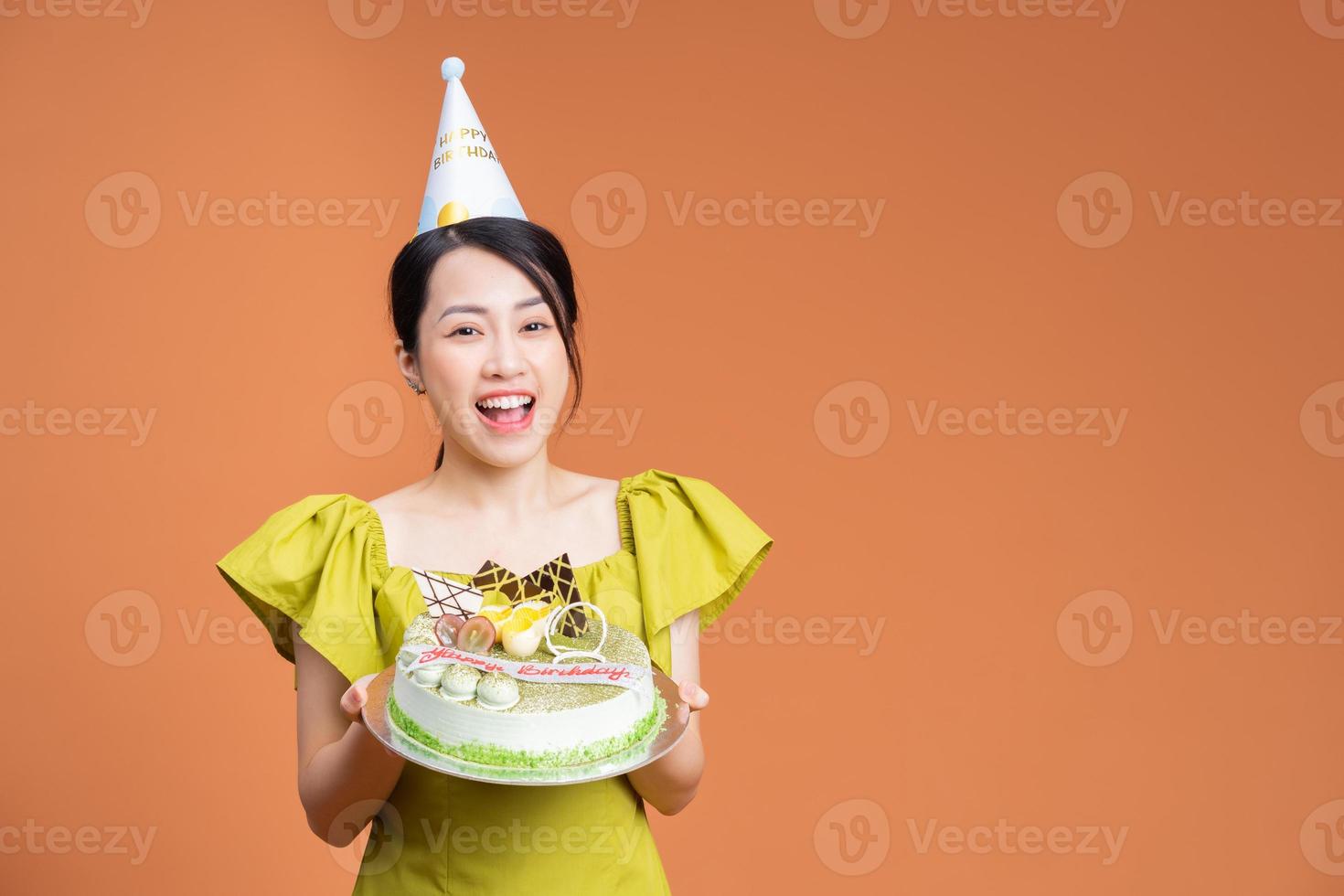 Young Asian woman holding birthday cake photo