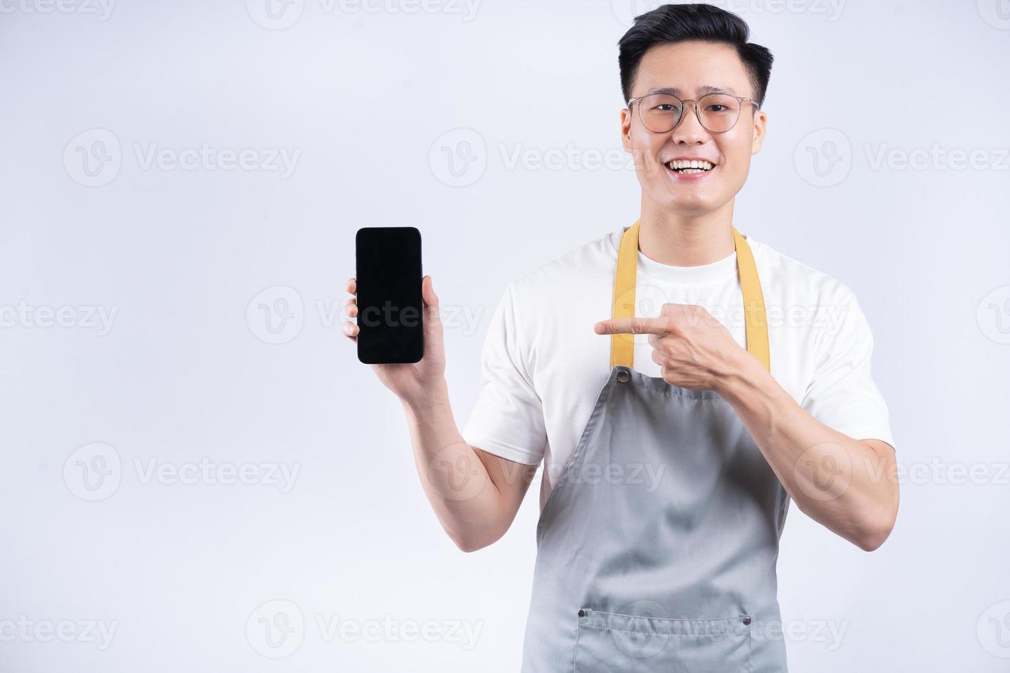 Image of young Asian waiter on background photo