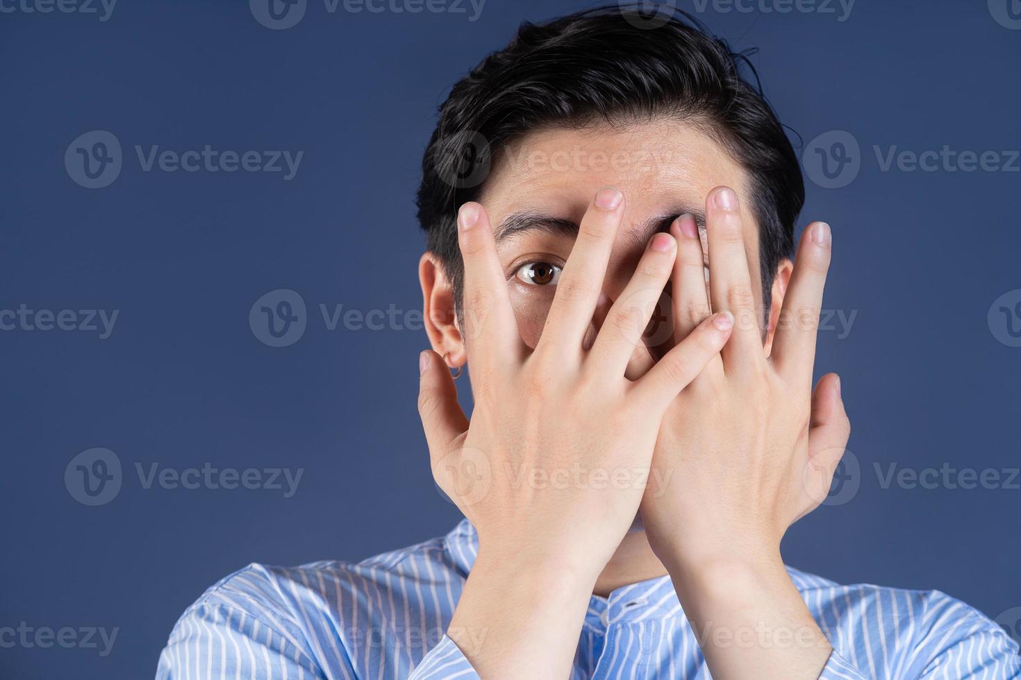 Young Asian man posing on background photo