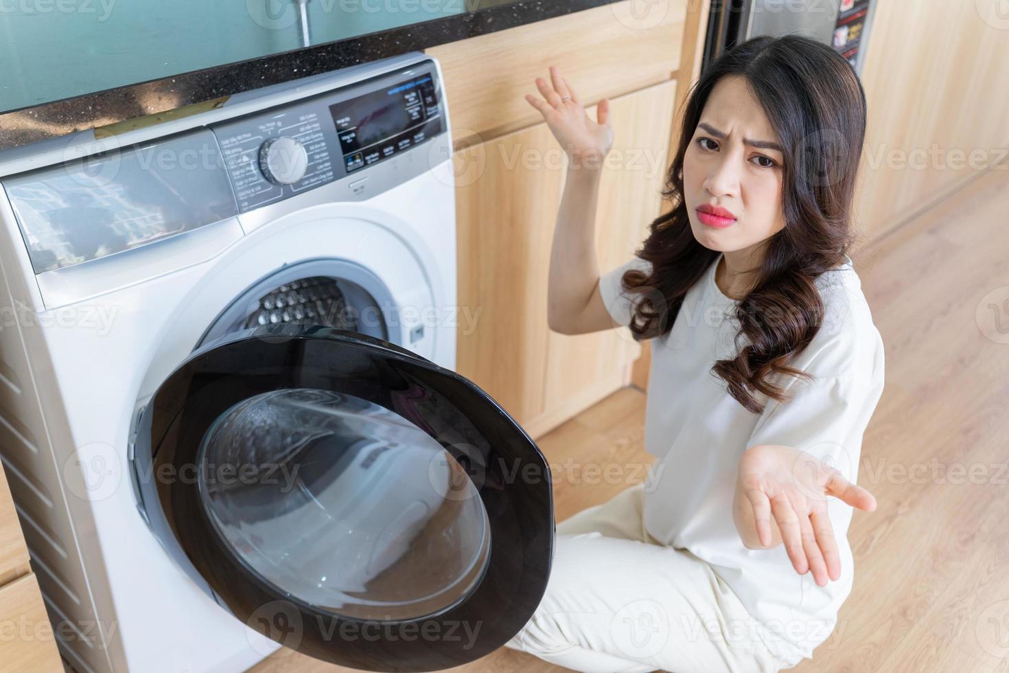 Image of Young Asian woman washing clothes photo