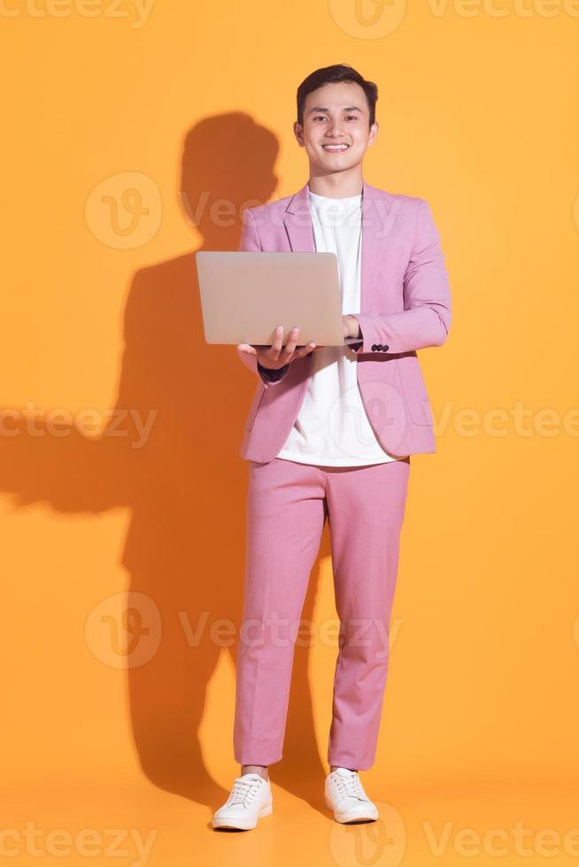 Portrait of young Asian man posing on background photo