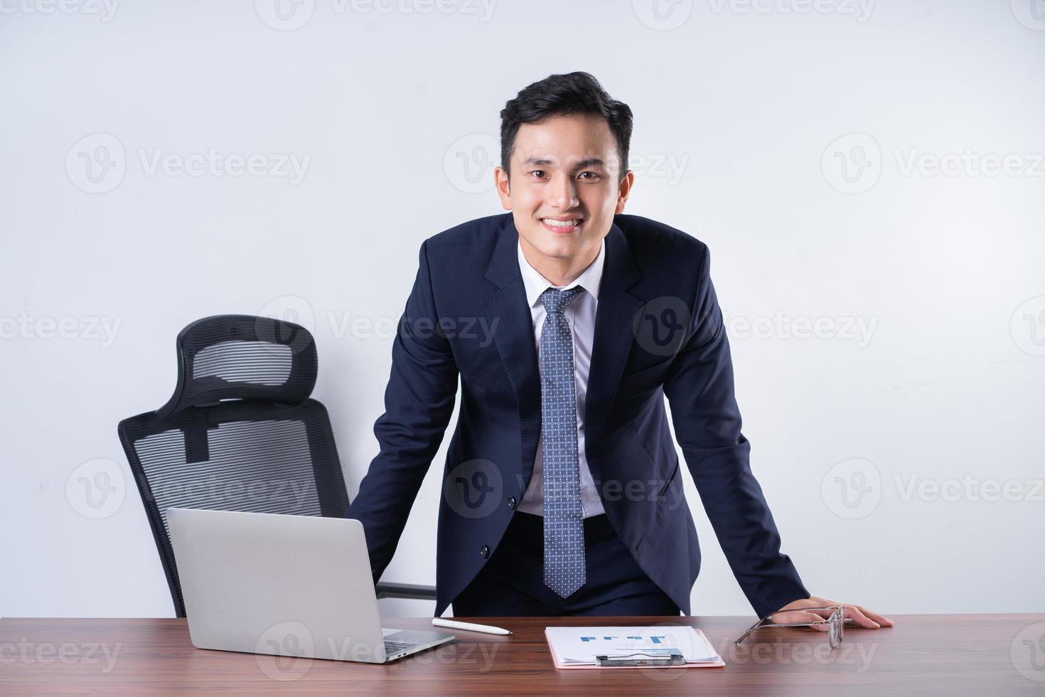 Image of young Asian businessman on background photo