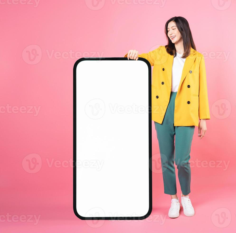 Image of young Asian businesswoman with smartphone mock up photo