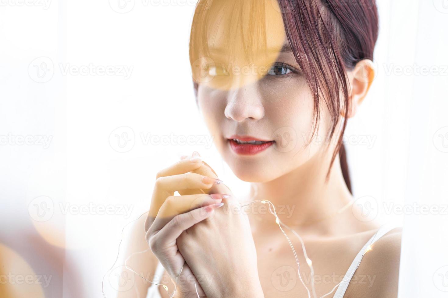 Beauty image of young Asian woman at home in the morning photo