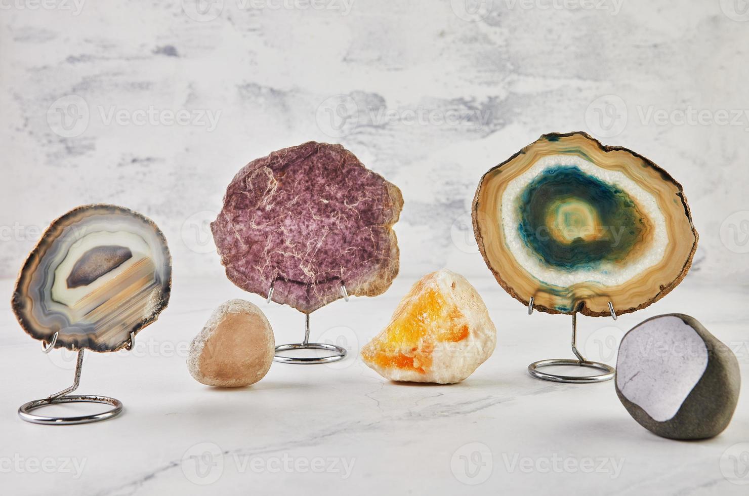 Collection of semi-precious stones of different colors and patterns on white background photo