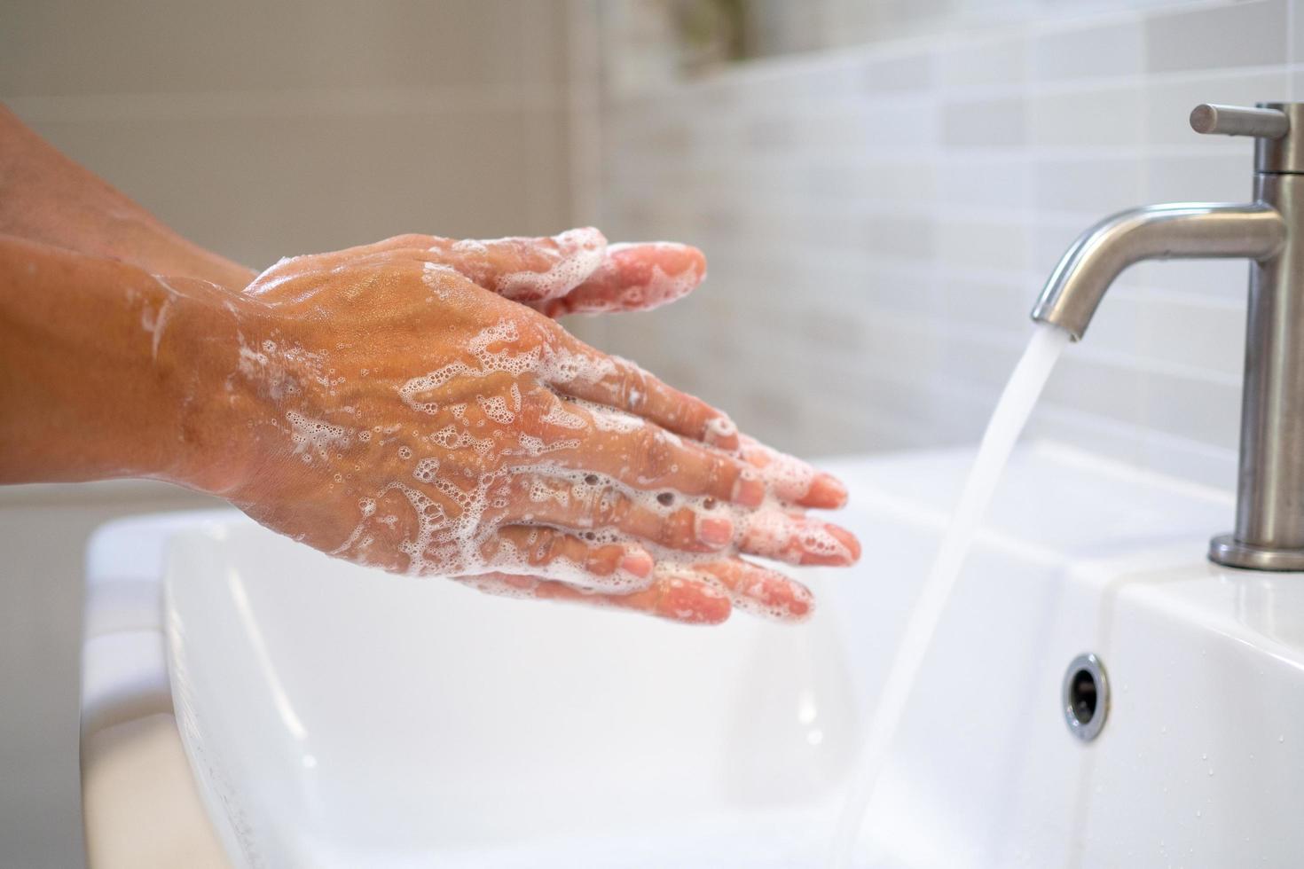 Women using gel to wash hands and turn on water to wash is the treatment and prevention of infections or viruses that are currently spreading around the world. photo